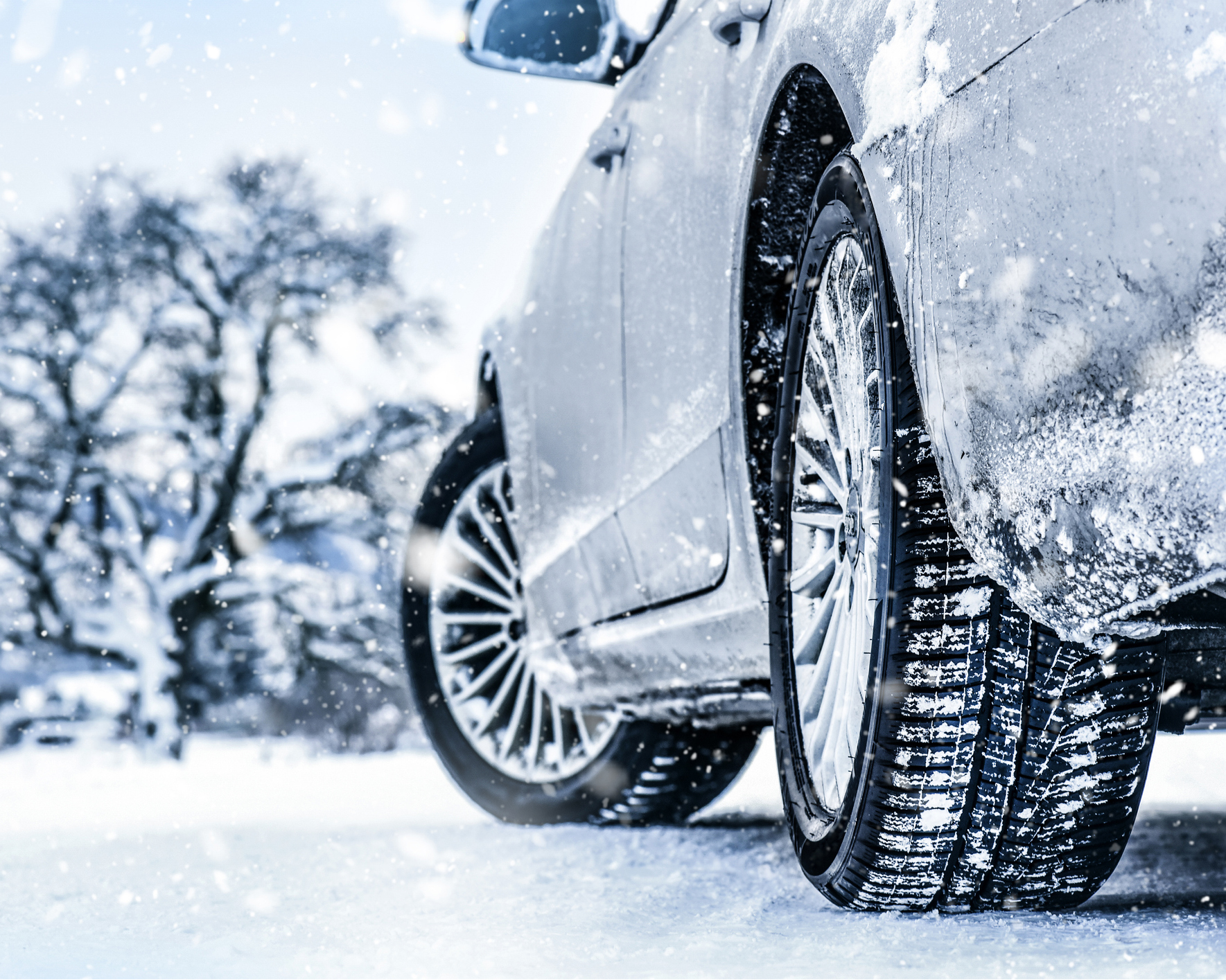 Winter tire. Car in winter. Tires on snowy road detail 